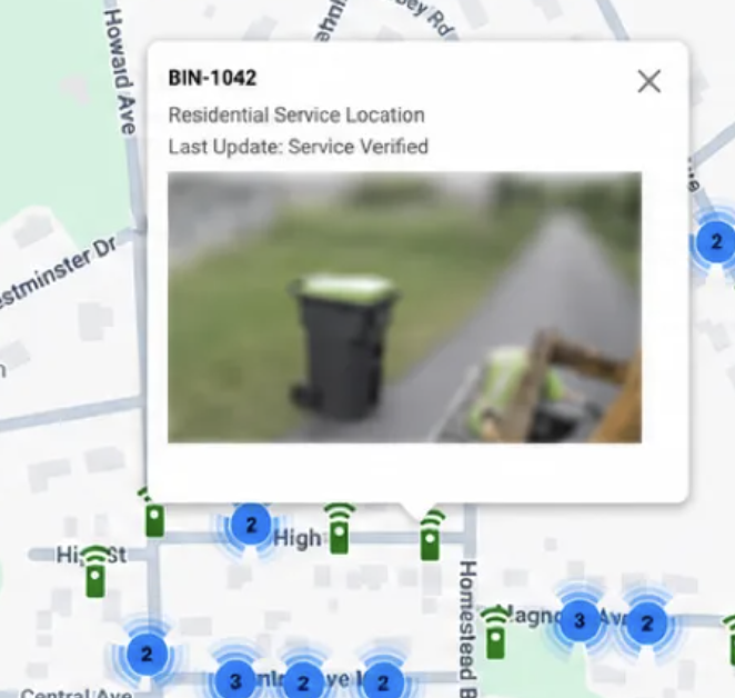 Fleet.Net map showing bin BIN-1042 with a service-verified status and collection photo